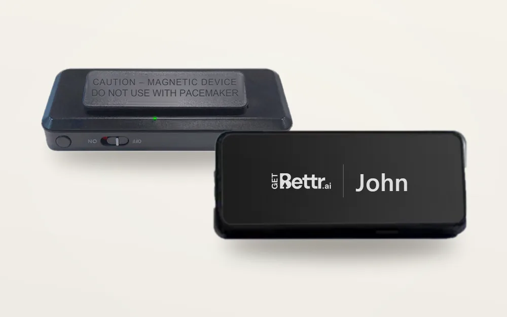 The GetBettr wearable recording nametag, seen from the back with its magnetic clip and from the front with the GetBettr logo and the name John on its screen